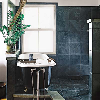 bathroom with dark ceramic tiled walls