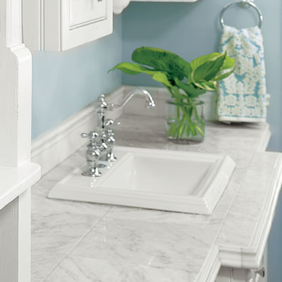 a bathroom counter made from marble floor tiles