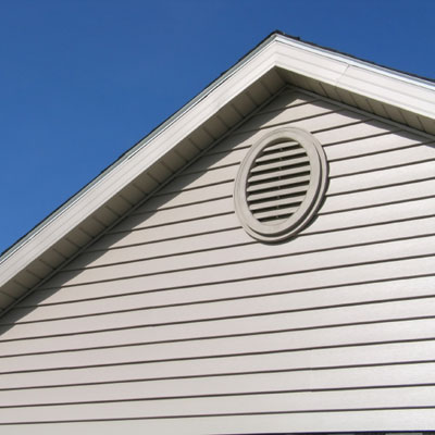 gable vent on clapboard house attic