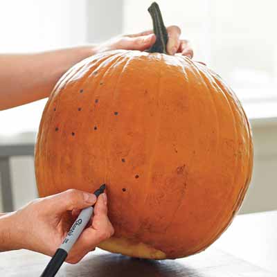 drilling designs into pumpkins and lighting them with strings of christmas lights