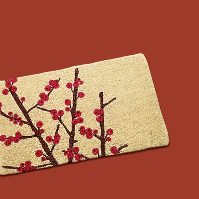 a welcome mat with winter berries design