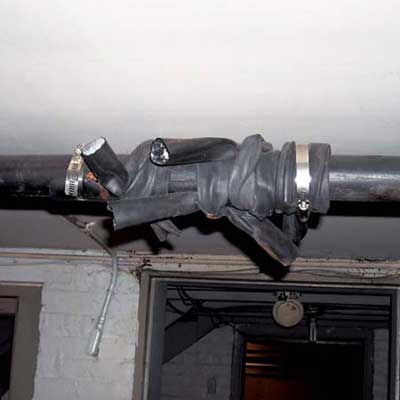 an old bicycle inner tube wrapped around a leaking steam pipe