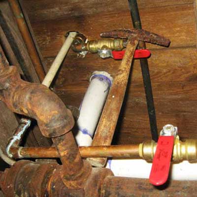 an old hammer wedged between two pipes
