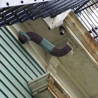 a downspout that ends just below the second story