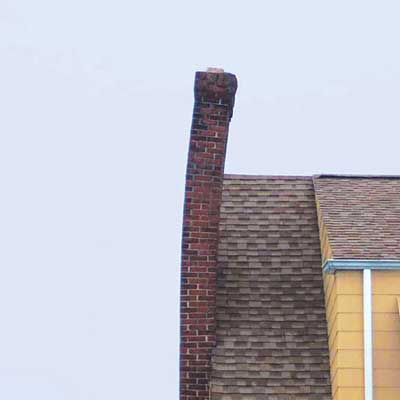 a chimney that is tilting perilously