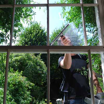 person cleaning house window