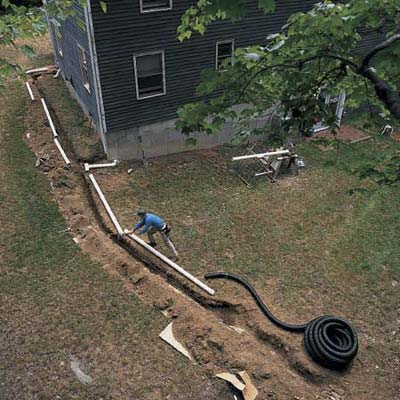 man extending down spout