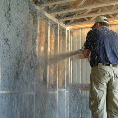 man spraying insulation 