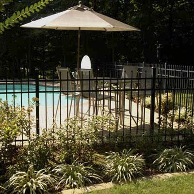 child home safety, child-proofing, and accidental injury prevention in the yard and near pools: backyard with fenced in swimming pool
