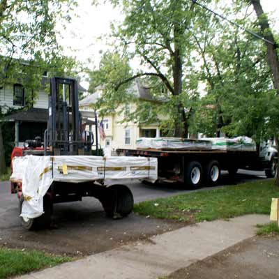 a flatbed truck filled with siding from James Hardie