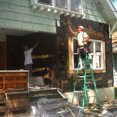 the homeowners help out with tearing off the original siding