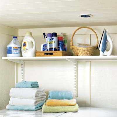 adjustable shelves built above the corner laundry nook built in this remodeled basement