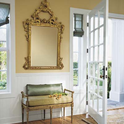 Entryway with ornate mirror and sitting bench