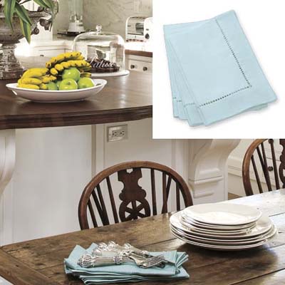 Blue dinner napkins add color to white kitchen