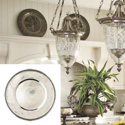 pewter chargers dress up a white kitchen wall
