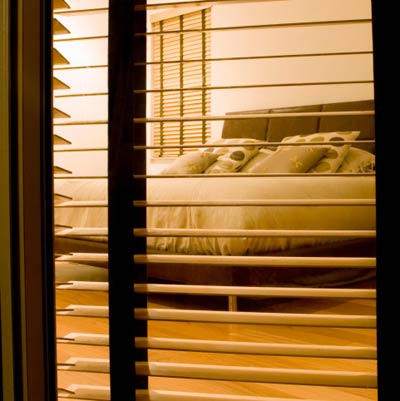 view of bedroom through open black out blinds