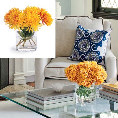 well furnished living room with yellow orange bouquet in glass vase
