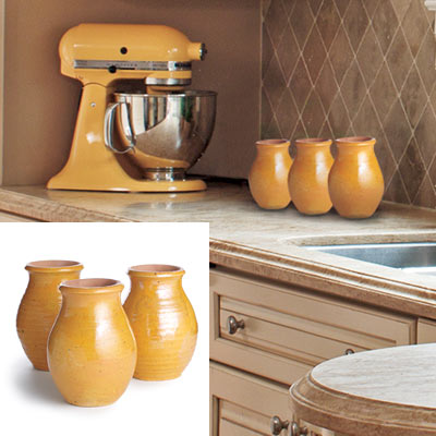 kitchen with taupe tile backsplash and yellow accents