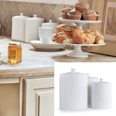 kitchen with taupe tile backsplash and white canisters