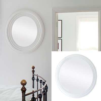 light airy bedroom with round mirror