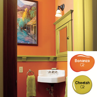 orange and green powder room with gaugin print