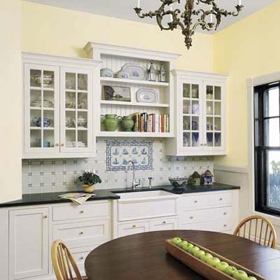 White open shelving and glass-front cabinets in this remodeled kitchen