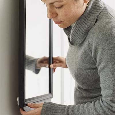 use a packing peanuts as spacers on the back corners of mirrors or frames