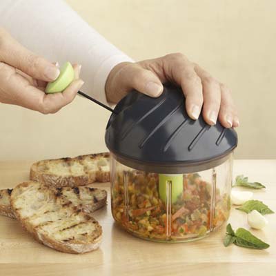 woman using swiss chop chop by kuhn rikon to mince vegetables