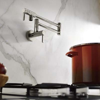pot filler faucet attached to marble wall above stove