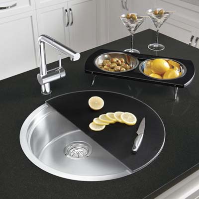 round sink with half-moon cutting board and tray with bowls