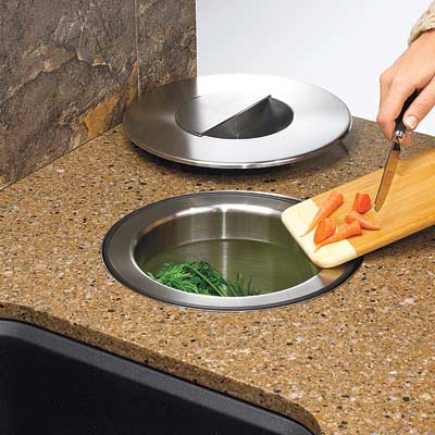 woman sliding carrot tips into in counter compost bucket