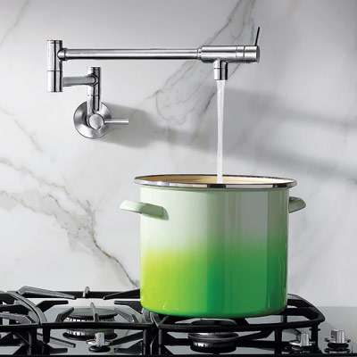 moen's modern show house pot filler filling up large pot on stove top