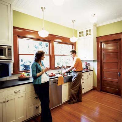 homeowners in remodeled kitchen of this victorian and craftsman style cottage