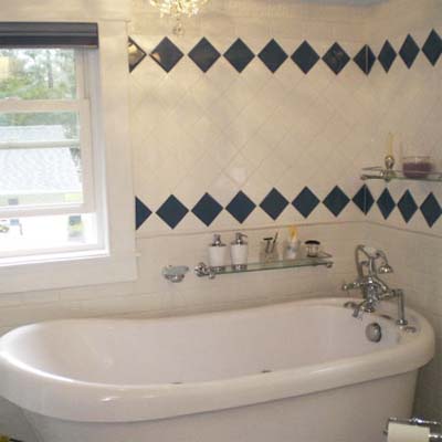 updated bathroom with tile and claw foot tub