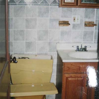 outdated bathroom with yellow toilet