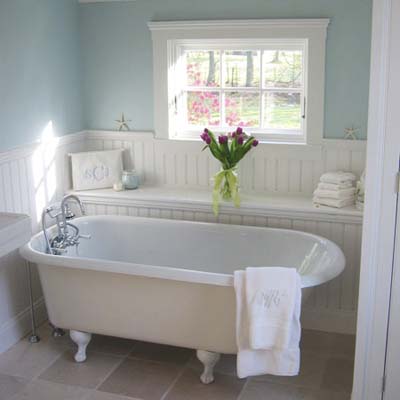 blue bathroom with white claw foot tub