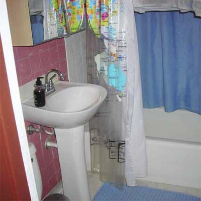pedestal sink in outdated bathroom