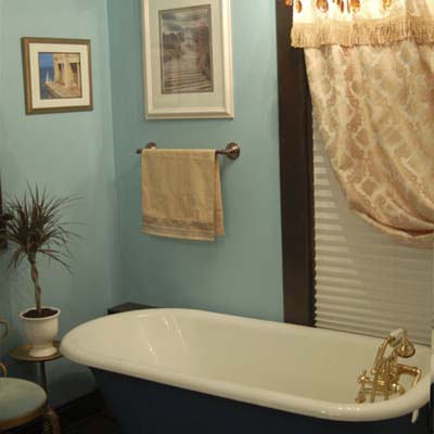 remodeled bathroom with blue walls and claw foot tub