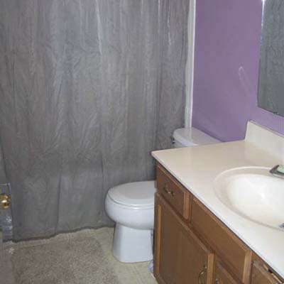 outdated bathroom with purple walls