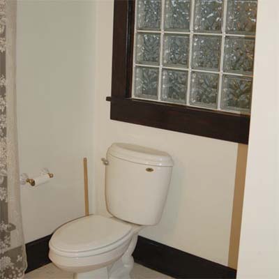 unfinished bathroom with glass tile window