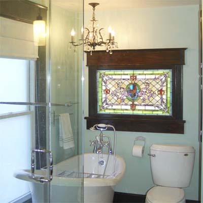 remodeled bathroom with stained glass window and chandelier