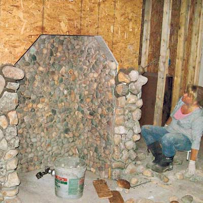 woman building stone hearth