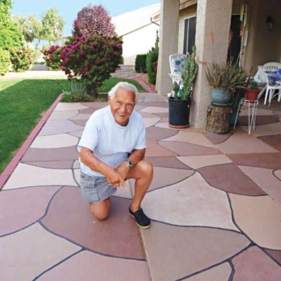 older man kneeling on patio