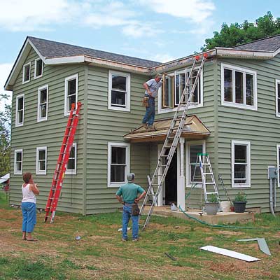 men working on exterior of house