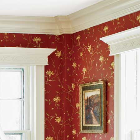 crown molding and vintage wallpaper grace the master suite in this remodeled greek revival
