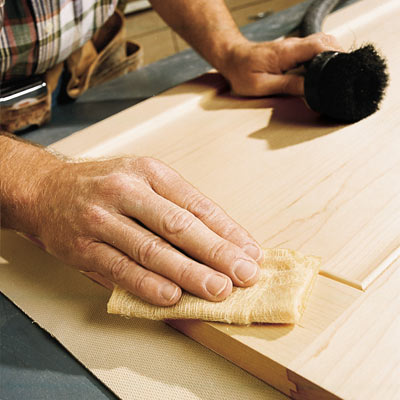 man cleaning up after using random orbit sander