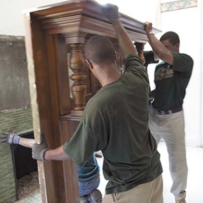 crew members removing fireplace mantel