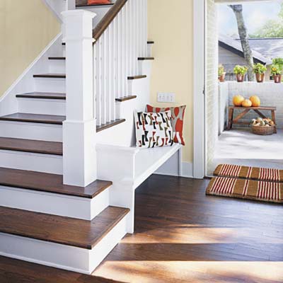 front door entrance of sustainable home has built-in bench; hardwood floors are partially salvaged