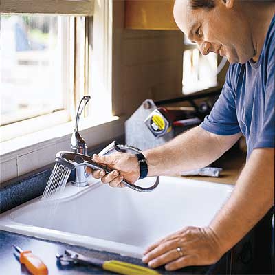 person testing a newly installed kitchen faucet