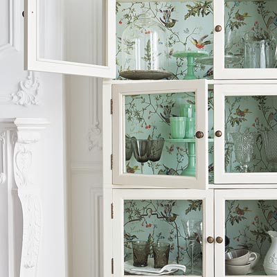 Tropical Birds vinyl-coated wallpaper inside a glass-front cabinet